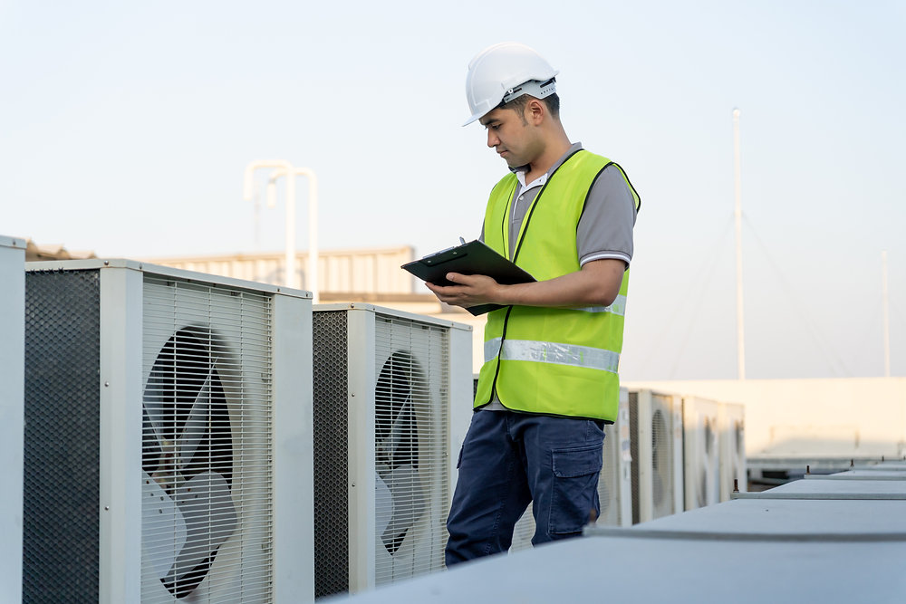 Technician checking ventilation equipment
